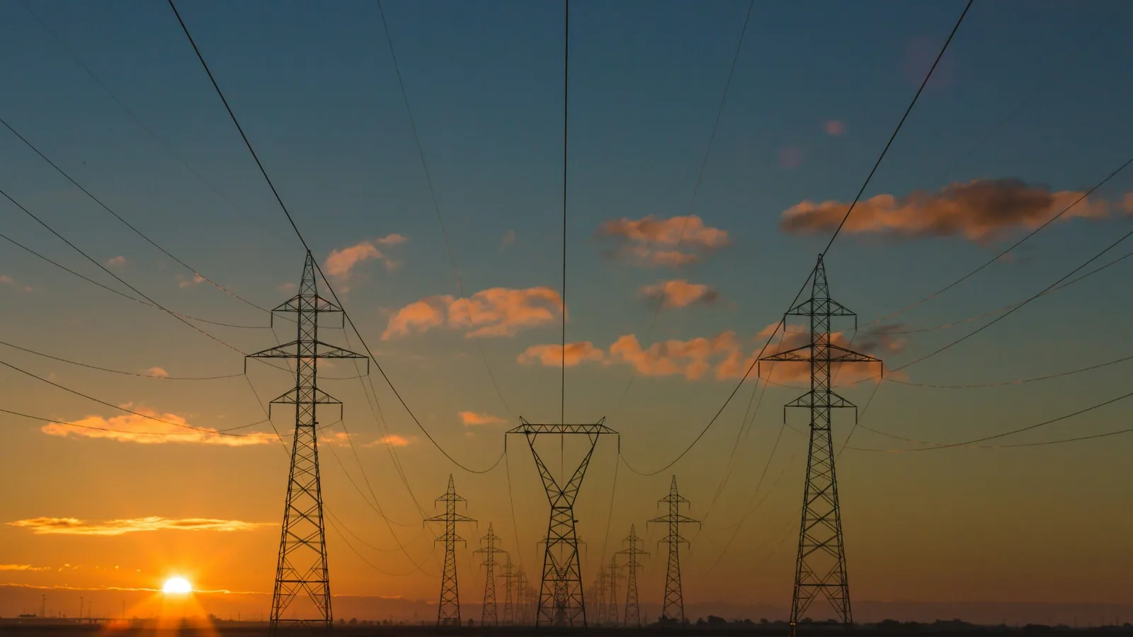 Hoogspanningsmasten bij zonsondergang